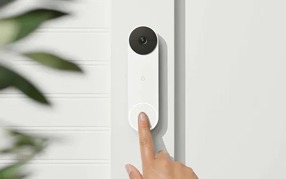 Homeowner testing a newly installed video doorbell for home security.