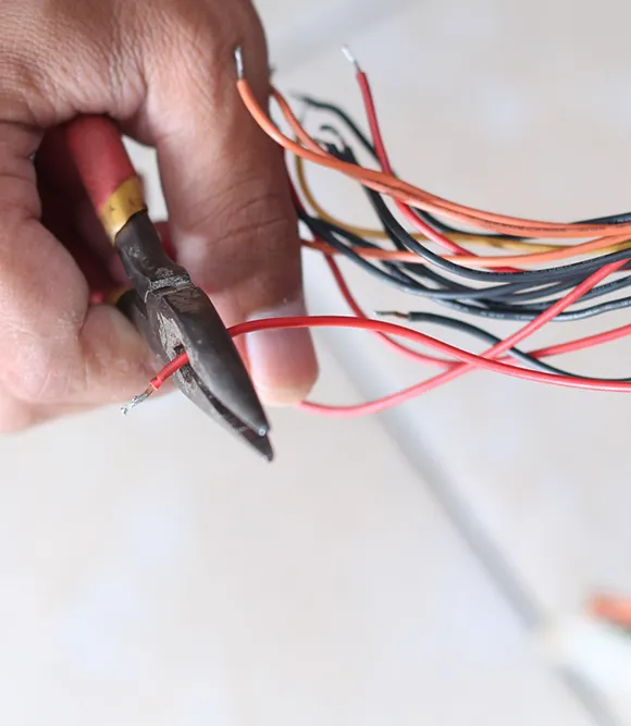 Technician repairing damaged electrical wires to restore safe and reliable power.