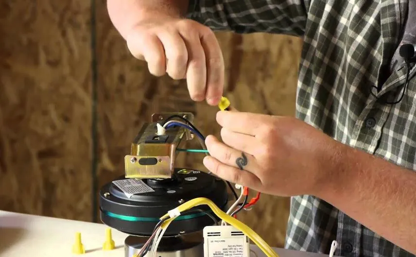 Ceiling fan motor repair expert diagnosing and fixing a broken fan motor.