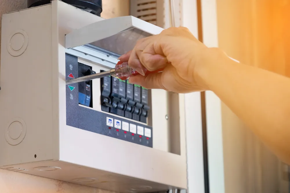 Circuit breaker repair specialist fixing a broken breaker to keep the electricity safe and working properly.