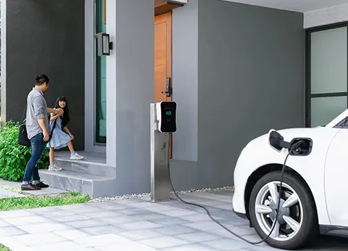 Electric vehicle charging at a home EV charging station designed for convenience and sustainability.