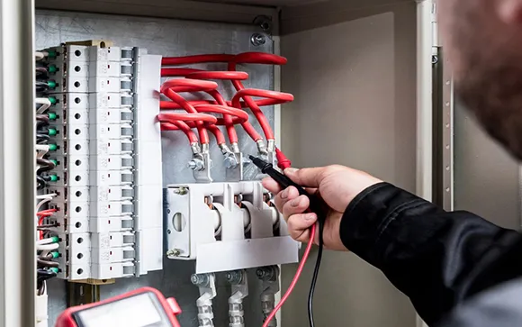 An electrical outlet expert installing a new outlet for safe and easy power access.