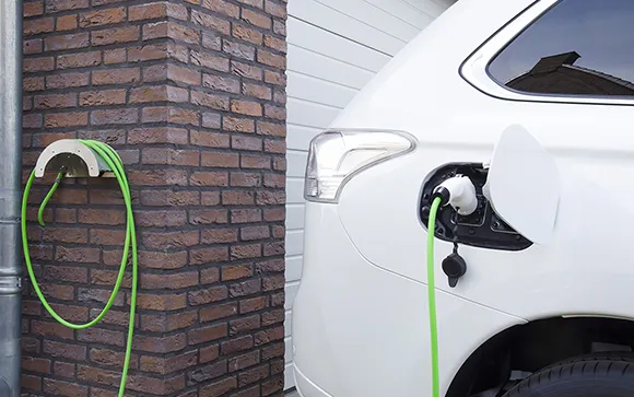 Close-up of an electric vehicle charger, charging an electric car.