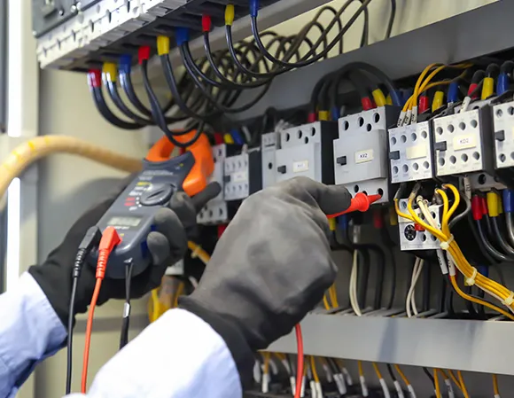 A skilled residential electrical wiring expert using a multimeter to test the home's electrical system.