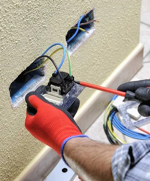 Electrician installing new wiring in a residential home to improve the electrical system.