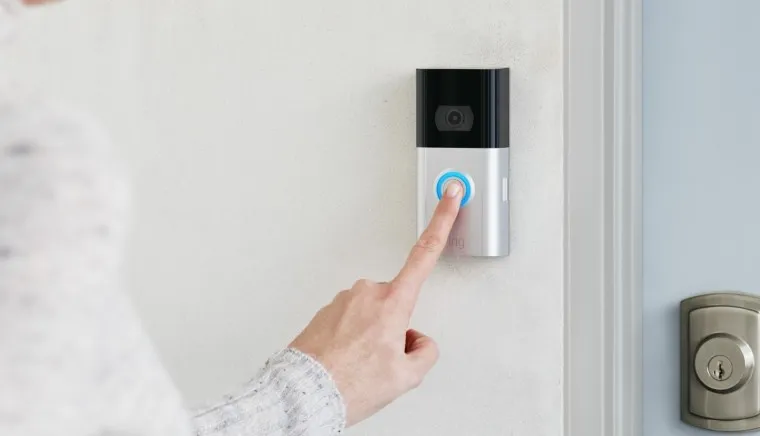 Homeowner testing a newly installed residential doorbell to ensure proper functionality.